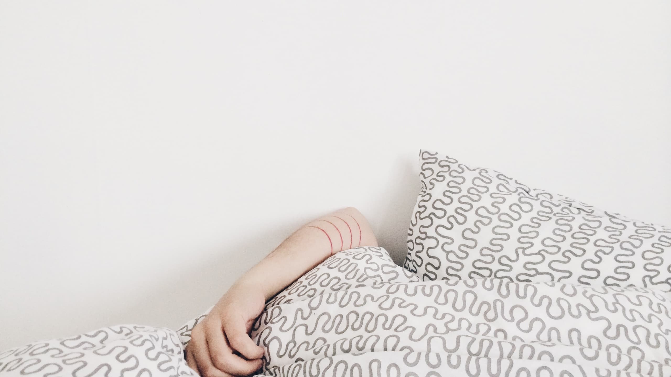 Person sleeping under blankets