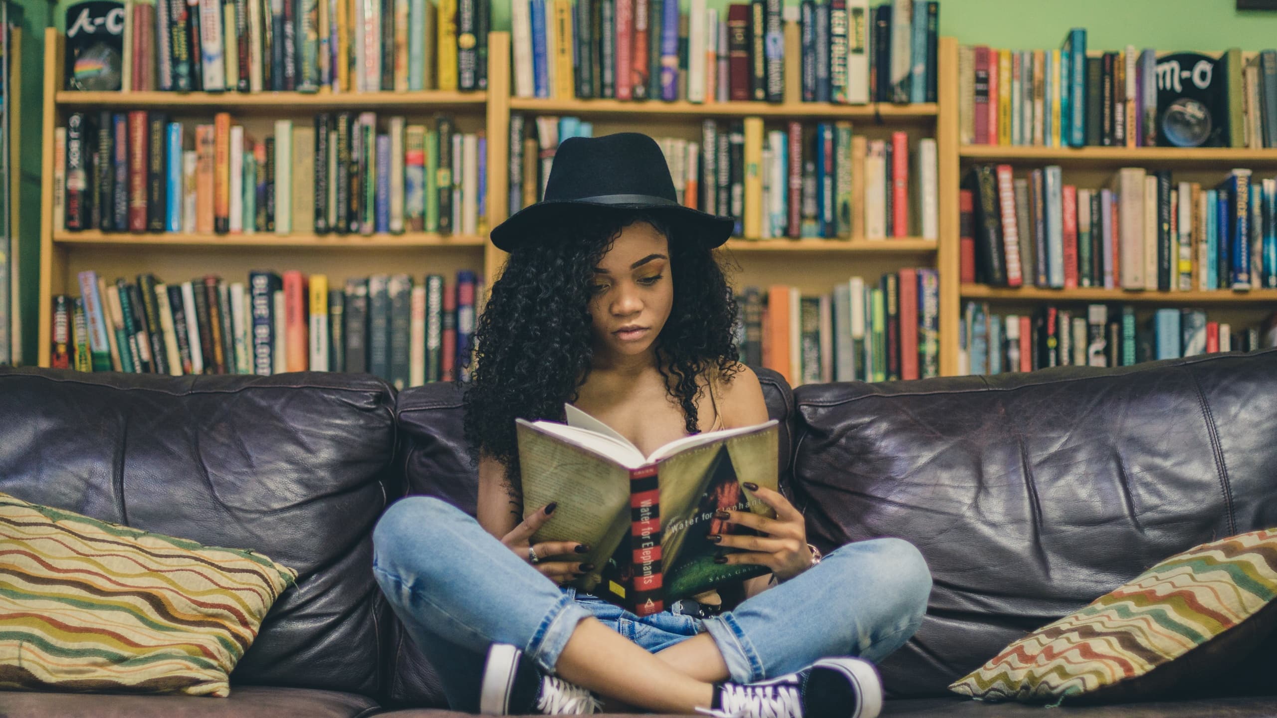 Woman sitting while mindfully reading book