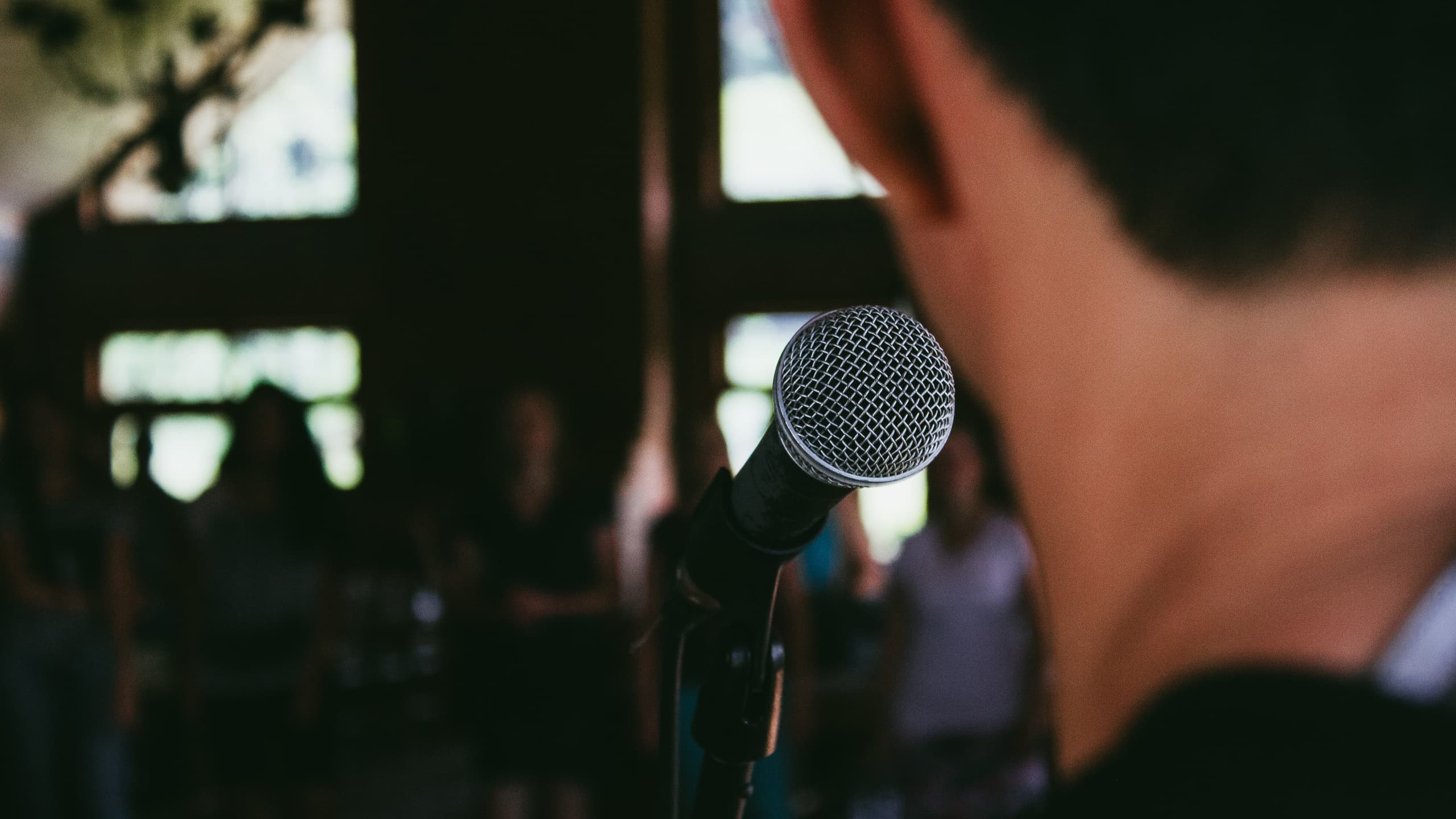 Man speaking to crowd with microphone