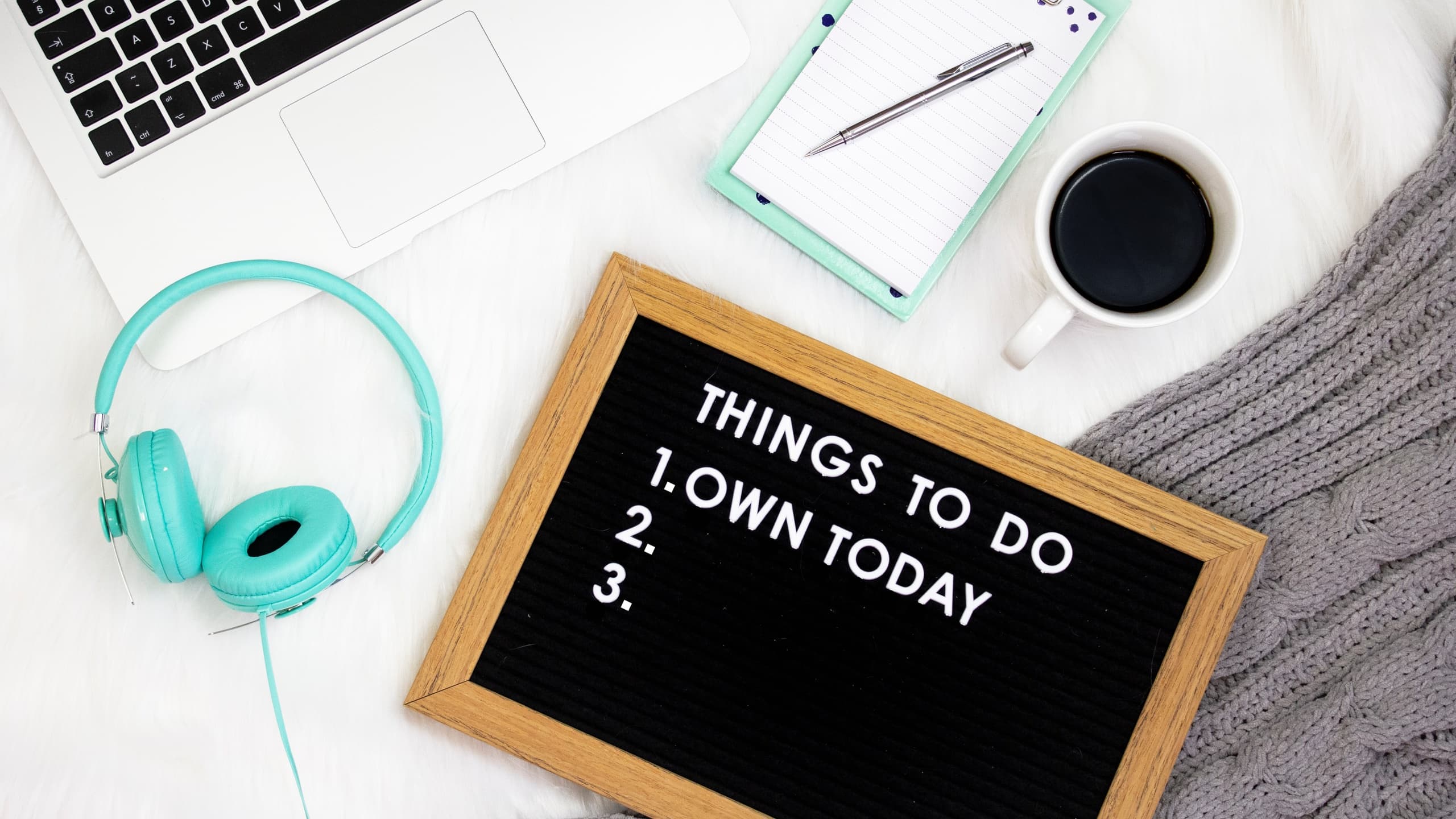 To do list with headphones, notebook, and coffee