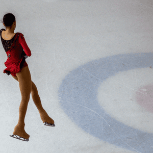 Woman performing figure skating jump