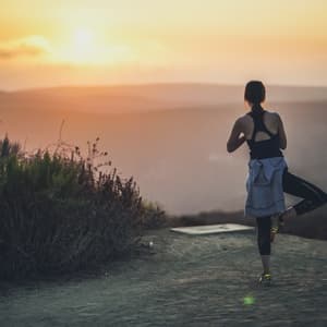 Woman doing yoga on mountaintop